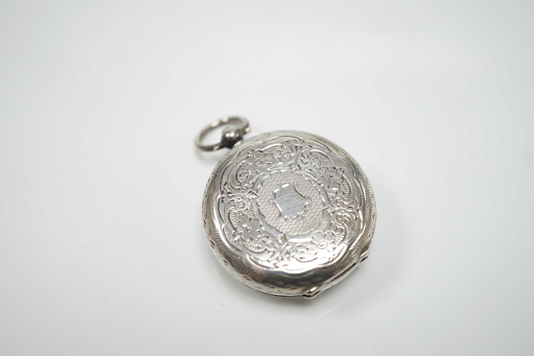 A George V silver mounted fob watch stand, Birmingham, 1923, 79mm, containing a Swiss white metal fob watch.